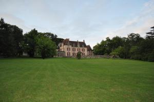 a large house with a large field of grass at Château Logis de Roche in Clairac