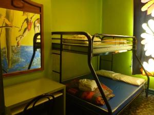 a room with two bunk beds and a mirror at EKONO HOSTEL LA BELLE PLANETE BACKPACKERS Downtown Quebec City in Quebec City