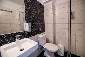 a bathroom with a sink and a toilet and a mirror at Ponti Beach Hotel in Vasiliki