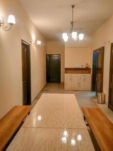 a large kitchen with wooden floors and a table at The Desire Hostel in New Delhi
