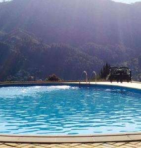 a swimming pool with a view of a mountain at Vale de Azereiros Apartamentos in Geres