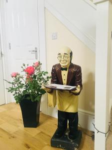 a statue of an older man holding a clipboard at Upton Country Park Guest House in Northampton