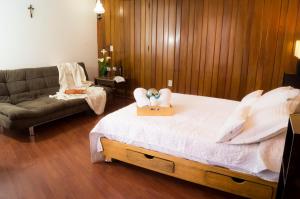 a bedroom with a bed with two people laying on it at Suite 1C, Balcon, Garden House, Welcome to San Angel in Mexico City