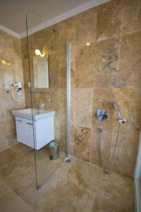 a bathroom with a shower and a sink at Kelebek Hotel in Kalkan