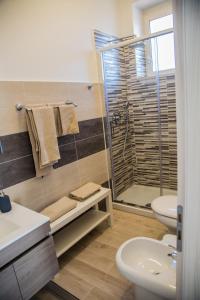a bathroom with a shower and a toilet and a sink at Home OLY in Gragnano +15 photos