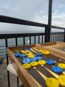 a table with yellow and blue frisbees on it at Skiron House in Skala Kallirachis