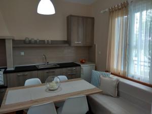 a kitchen with a table and chairs and a sink at Skiron House in Skala Kallirachis +38 photos