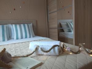 a bedroom with a bed with a book and lights at Skiron House in Skala Kallirachis