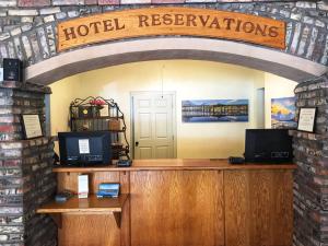 a hotel reception desk with a sign that reads hotel reservations at Pismo Beach Hotel in Pismo Beach