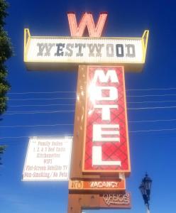 a sign for a west virginia motel with a sign for a sign at Westwood Motel in West Yellowstone