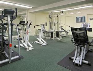 a gym with several treadmills and machines at Days Inn by Wyndham Arlington Pentagon in Arlington