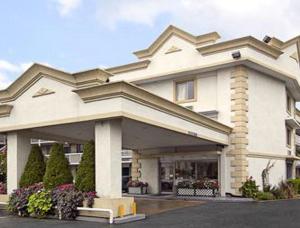 a large white building with a lot of flowers at Days Inn by Wyndham Arlington Pentagon in Arlington