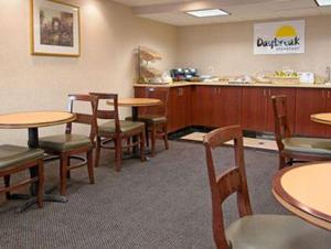 a restaurant with tables and chairs and a counter at Days Inn by Wyndham Arlington Pentagon in Arlington