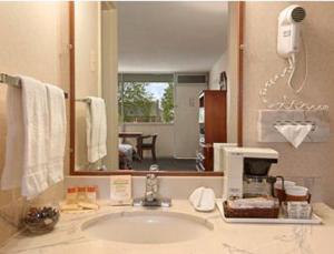 a bathroom with a sink and a mirror at Days Inn by Wyndham Arlington Pentagon in Arlington