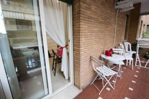 a balcony with a table and chairs on a patio at Asher's House Colosseum in Rome +26 photos