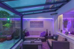 a living room with a couch on a balcony with purple lights at Enschede in Enschede