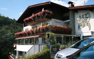 a building with flower boxes on the side of it at Gasthof Majestic in Bressanone