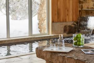 a table with two glasses and a bottle of wine at Breathtaker Hotel and Spa in Mount Buller