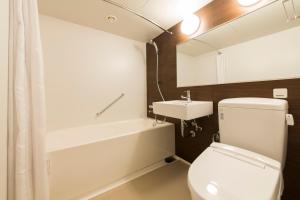 a bathroom with a toilet and a sink at Princess Garden Hotel in Nagoya