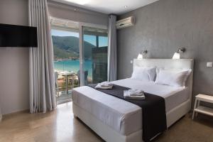 a bedroom with a bed with a view of the ocean at Ponti Beach Hotel in Vasiliki +30 photos