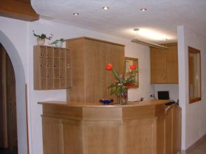 a kitchen with a counter with a vase of flowers at Gasthof Majestic in Bressanone