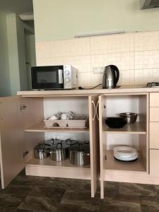 a kitchen with a counter with pots and pans at SV apartments in Zatoka