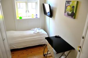 a small bedroom with a bed and a window at Rent a Room Copenhagen in Copenhagen