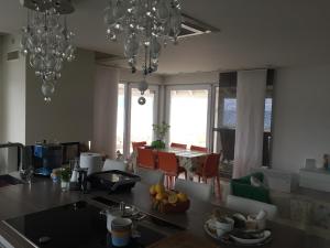 a kitchen with chandeliers and a kitchen with a counter top at Villa Niki in Soline