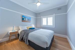 
a bedroom with a bed and a desk at Beach Retreat in Sydney
