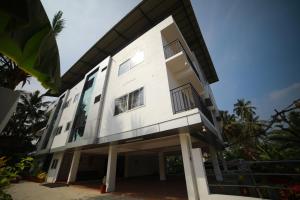 a white building with a lot of windows at Indeevaram Residency in Trivandrum
