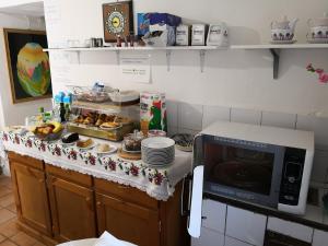 a kitchen counter with a microwave and some food at Palazzo Della Marra in Ravello