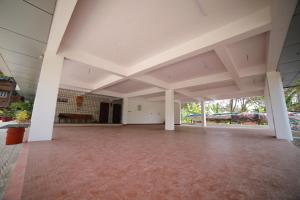 an empty room with white walls and white ceilings at Indeevaram Residency in Trivandrum