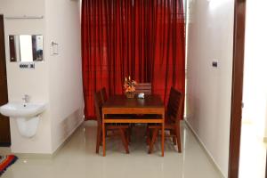 a dining room with a table and a sink at Indeevaram Residency in Trivandrum