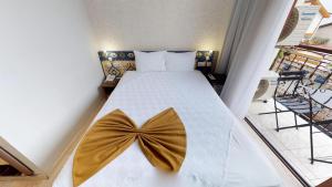 a bedroom with a bed with a bow on it at Patron Hotel in Antalya