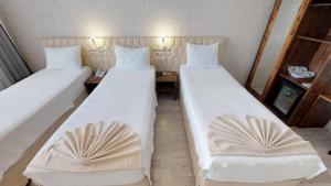 Postel nebo postele na pokoji v ubytování Patron Hotel