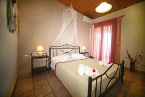 a bedroom with a bed with towels on it at Christianna Studios in Nikiana