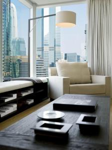 a living room with a couch and a large window at The Jervois in Hong Kong
