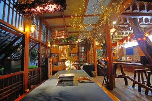a room with a table with books and christmas lights at Guihua Road 106th Hostel in Zhangjiajie