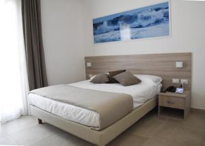 Postel nebo postele na pokoji v ubytování Hotel Belsito