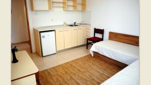 a small kitchen with a bed and a sink at Veda Guest House in Pomorie