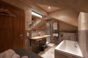 a bathroom with a sink and a bath tub at Chalet Alpin in Heiligenblut