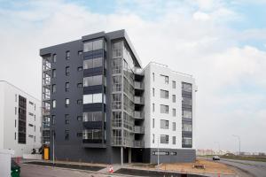 a large white building on the side of a road at Ocean View Luxury Apartment in Central Reykjavik in Reykjavík