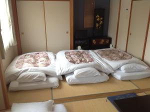 Postel nebo postele na pokoji v ubytování Hotel Hinodeya