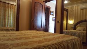 a bedroom with a bed and a door with a window at Villa SportLife in Lloret de Mar