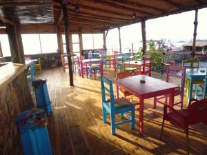 ein Restaurant mit bunten Tischen und Stühlen in einem Zimmer in der Unterkunft Casa De France in Porto Novo