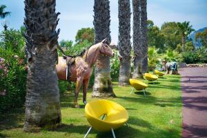 a horse statue in the middle of a park at Hotel Rurale Orti di Nora & SPA in Santa Margherita di Pula