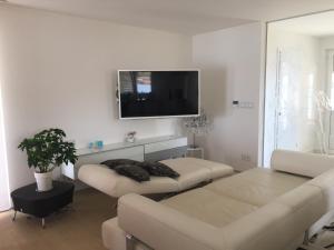a living room with a couch and a flat screen tv at Villa Niki in Soline