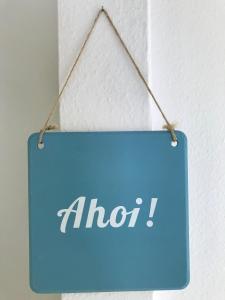a blue sign hanging on a wall with the word aloit at Ankerplatz Langballig in Langballig