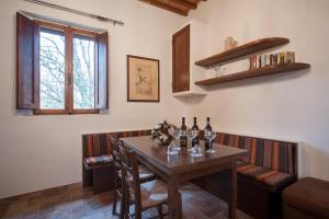 a dining room with a table with bottles of wine at Agriturismo Natura E Salute in San Gimignano
