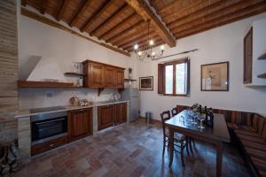 a kitchen with a table and a dining room at Agriturismo Natura E Salute in San Gimignano